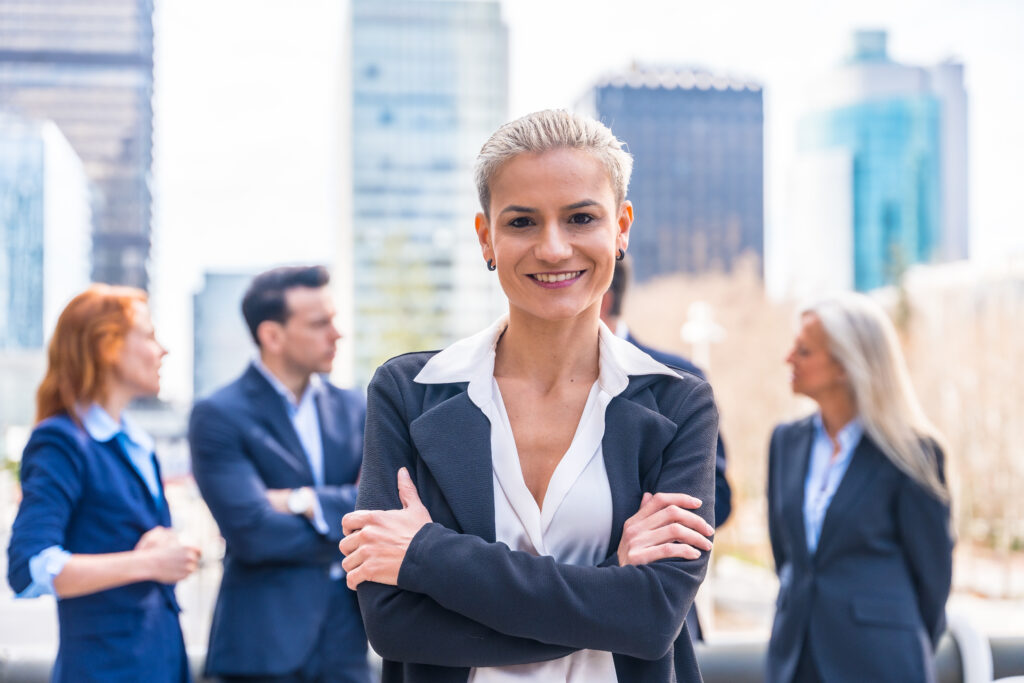 Confident businesswoman leading a professional team in a cityscape